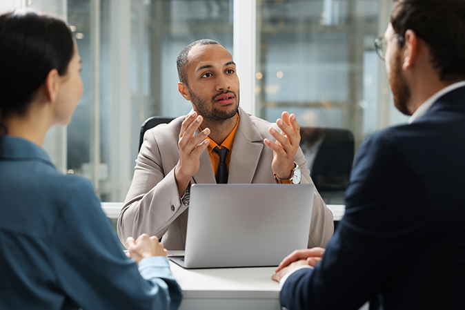 Lawyer working with clients at table in office