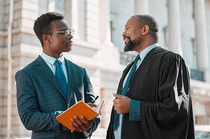 two male lawyers talking in the city.