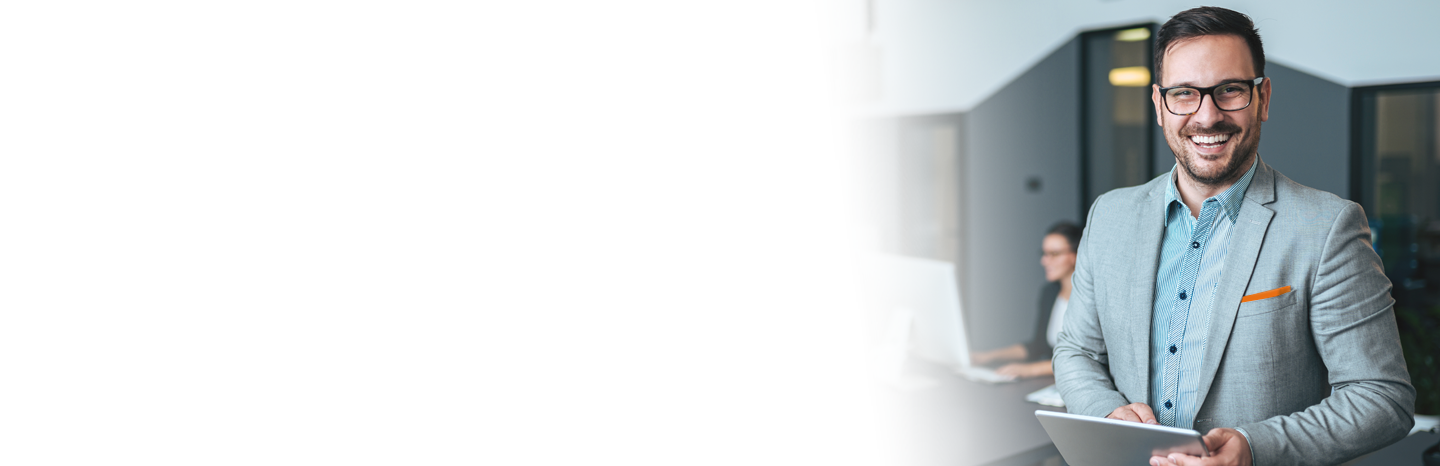 Smiling professional man holding a tablet in the office